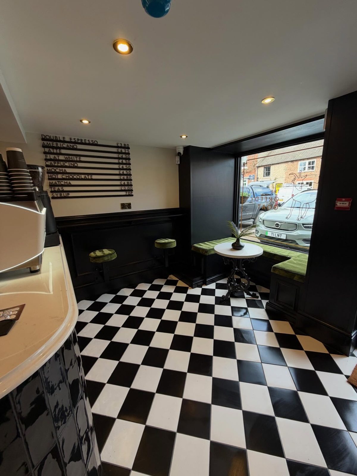 A café with a gleaming black and white chequered floor after a clean